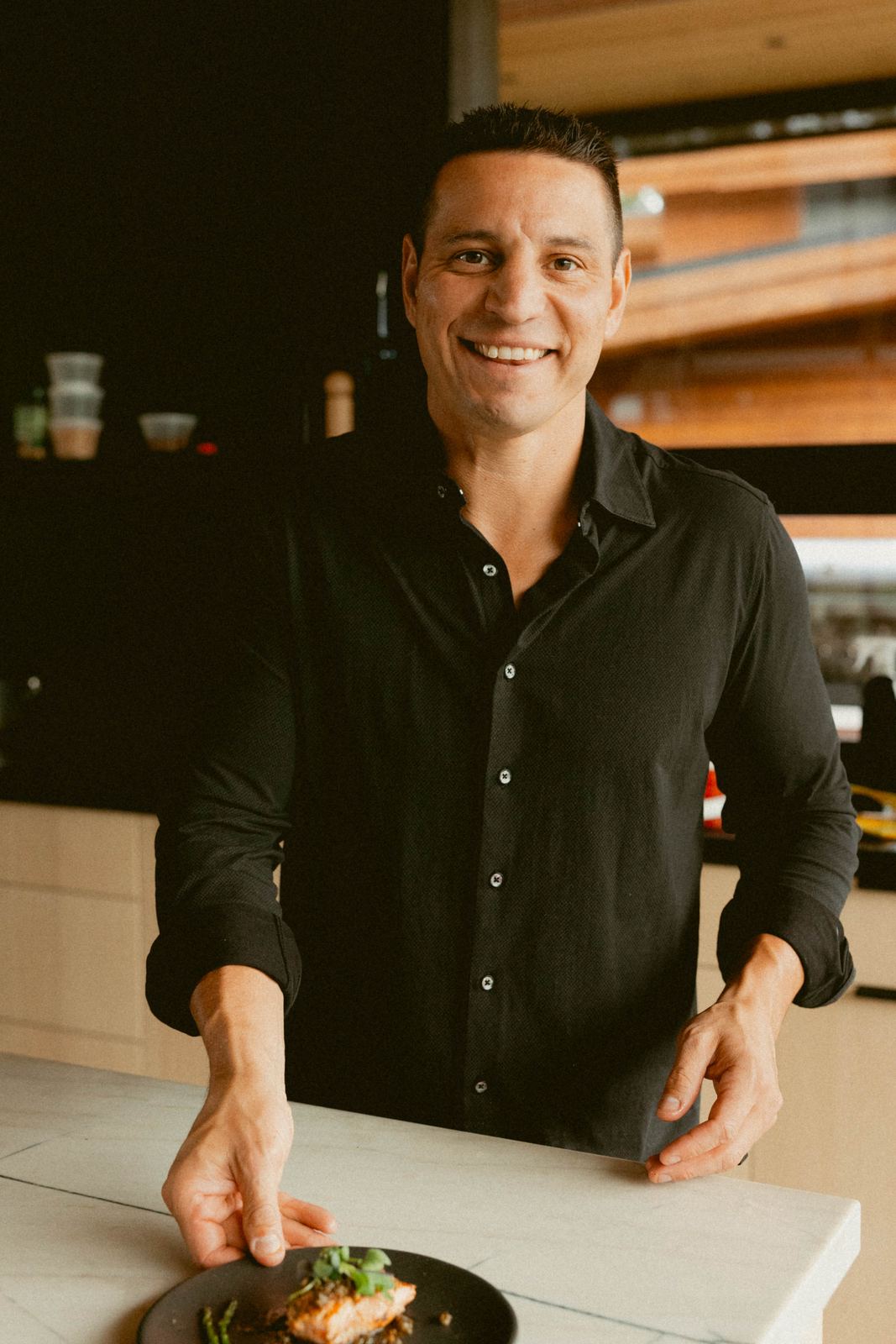 Caleb serving a plated course