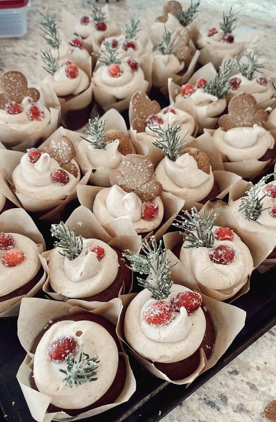 Holiday cupcakes with sugared cranberries and rosemary