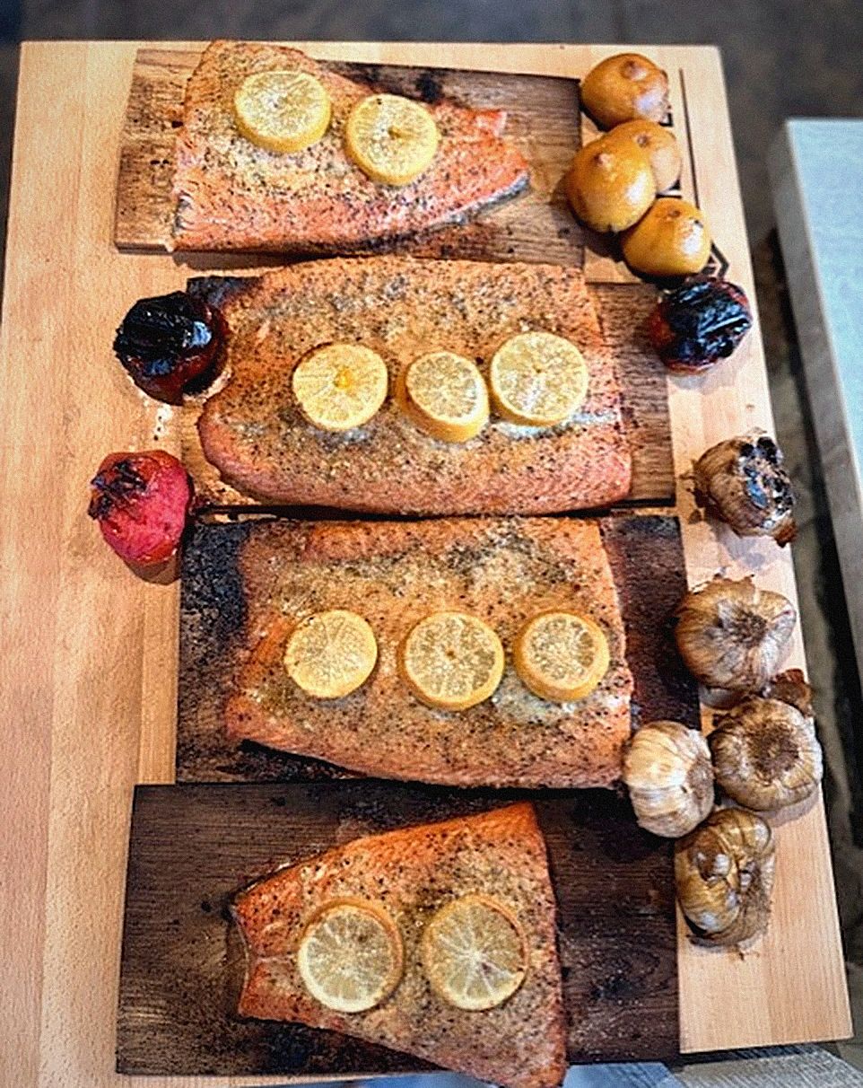 Cedar plank salmon with roasted garlic, served family-style
