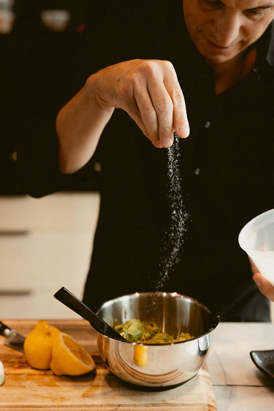 Seasoning a dish by hand with salt