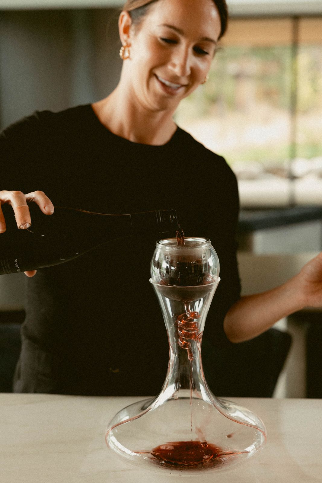 Pouring pinot noir through a decanter
